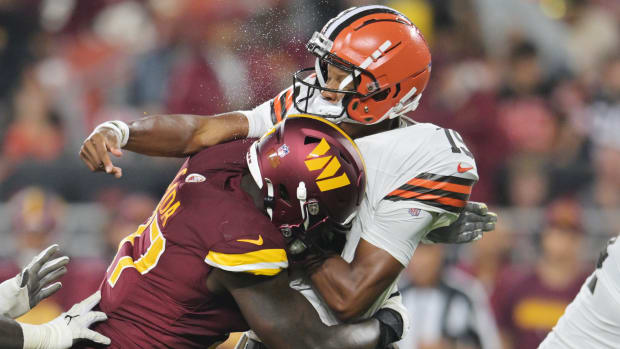 Washington Commanders defensive end Efe Obada (97) hits Cleveland Browns quarterback Joshua Dobbs (15) during the first half at Cleveland Browns Stadium.